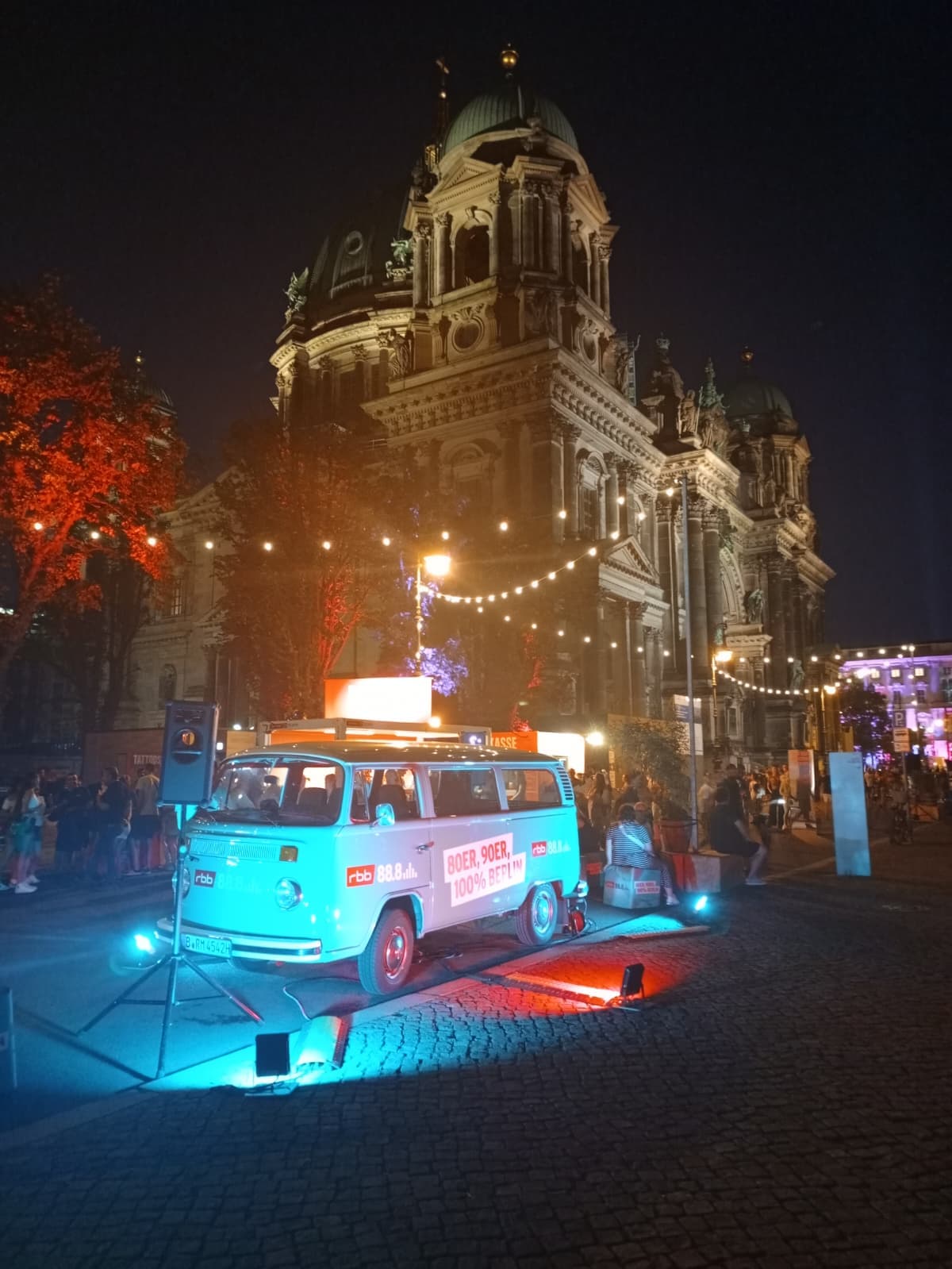 Night street view of Berlin Cathedral with a lit-up van.