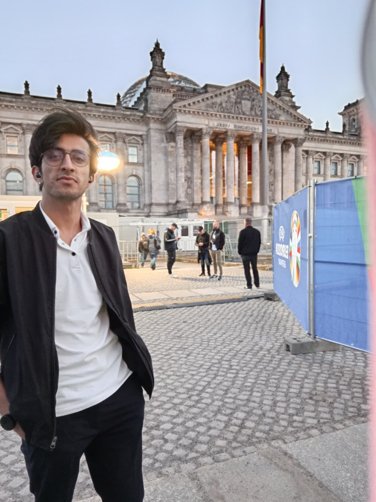In front of the Reichstag building during the evening.