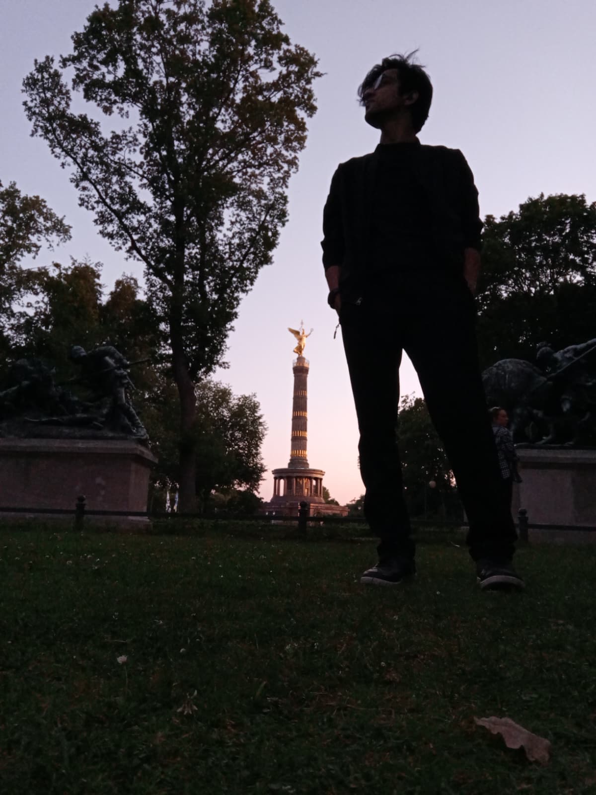 Silhouette in front of the Victory Column at dusk.