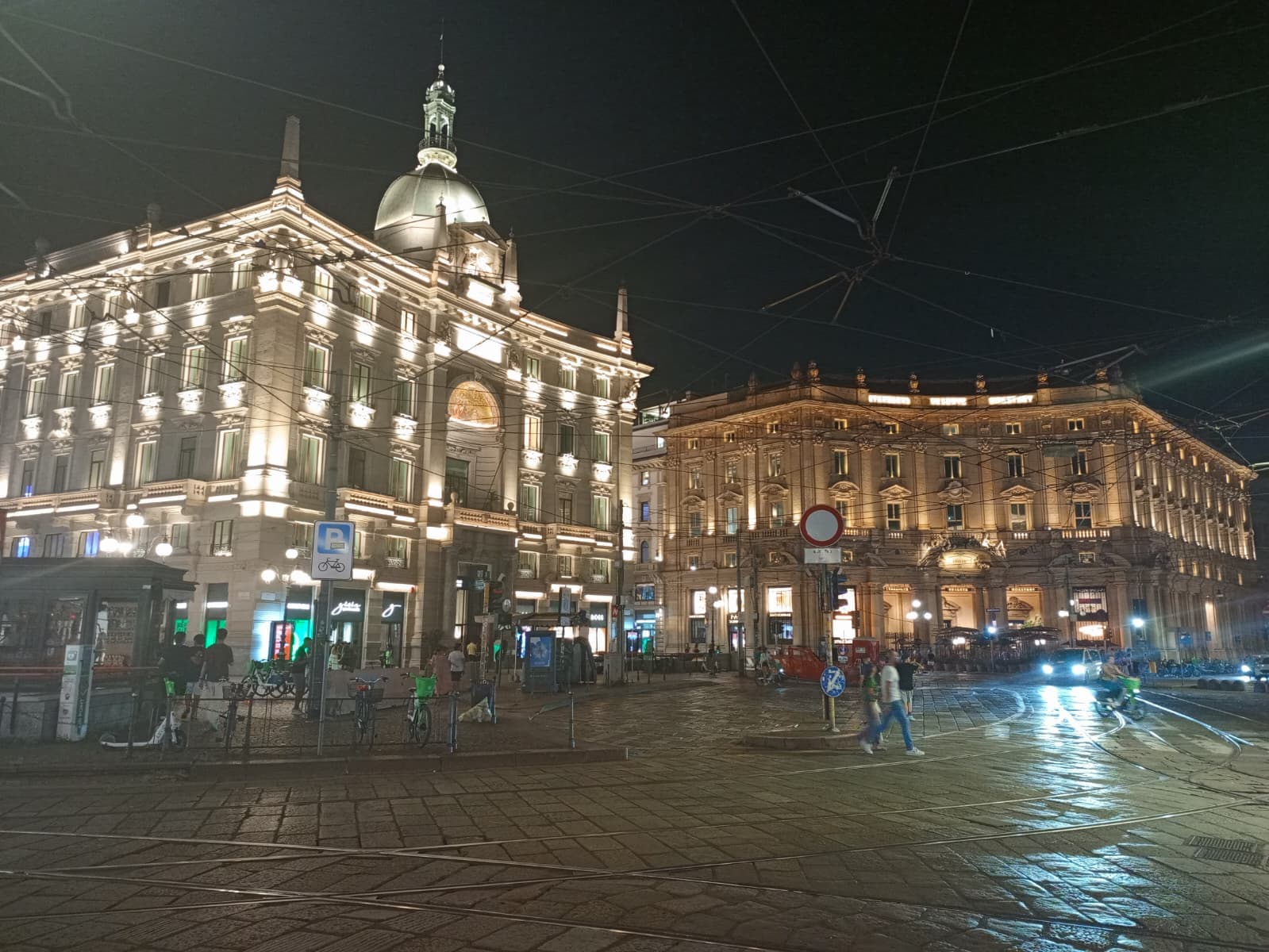 Night street view of Milan’s historic buildings.