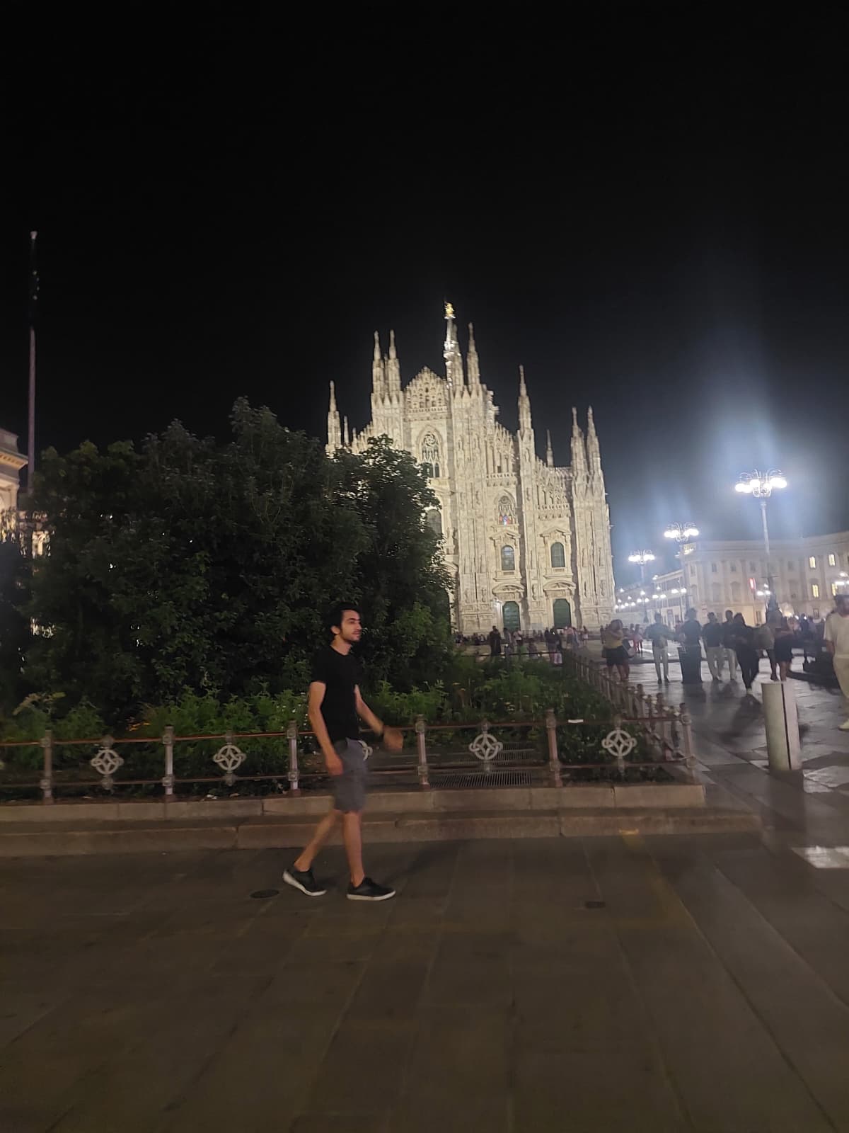 Walking near the Milan Cathedral at night.