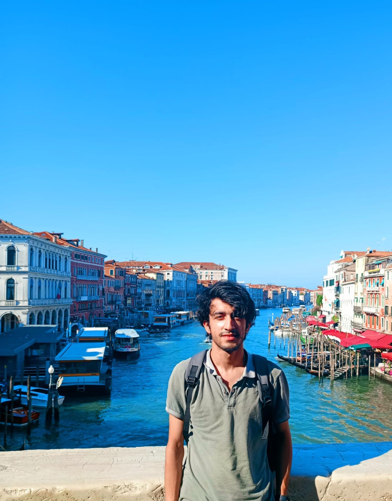 Standing on the Rialto Bridge with the Grand Canal stretching behind.