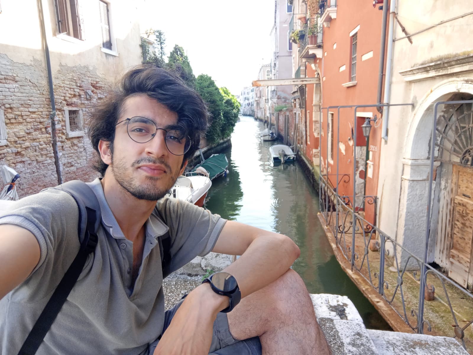Relaxing by a quiet side canal in Venice.
