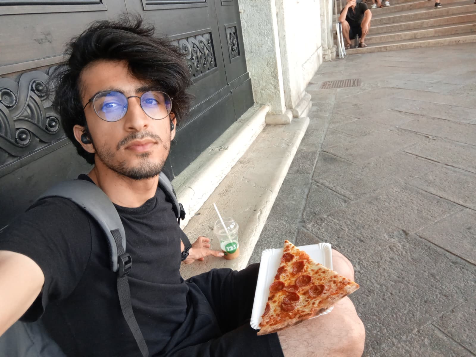 Taking a break with a slice of pizza in hand.
