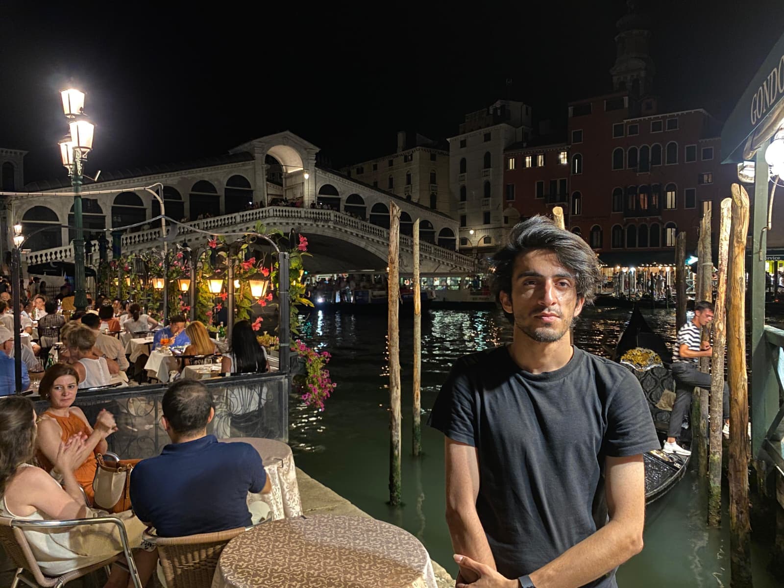Night by the Rialto Bridge, enjoying the lively atmosphere.