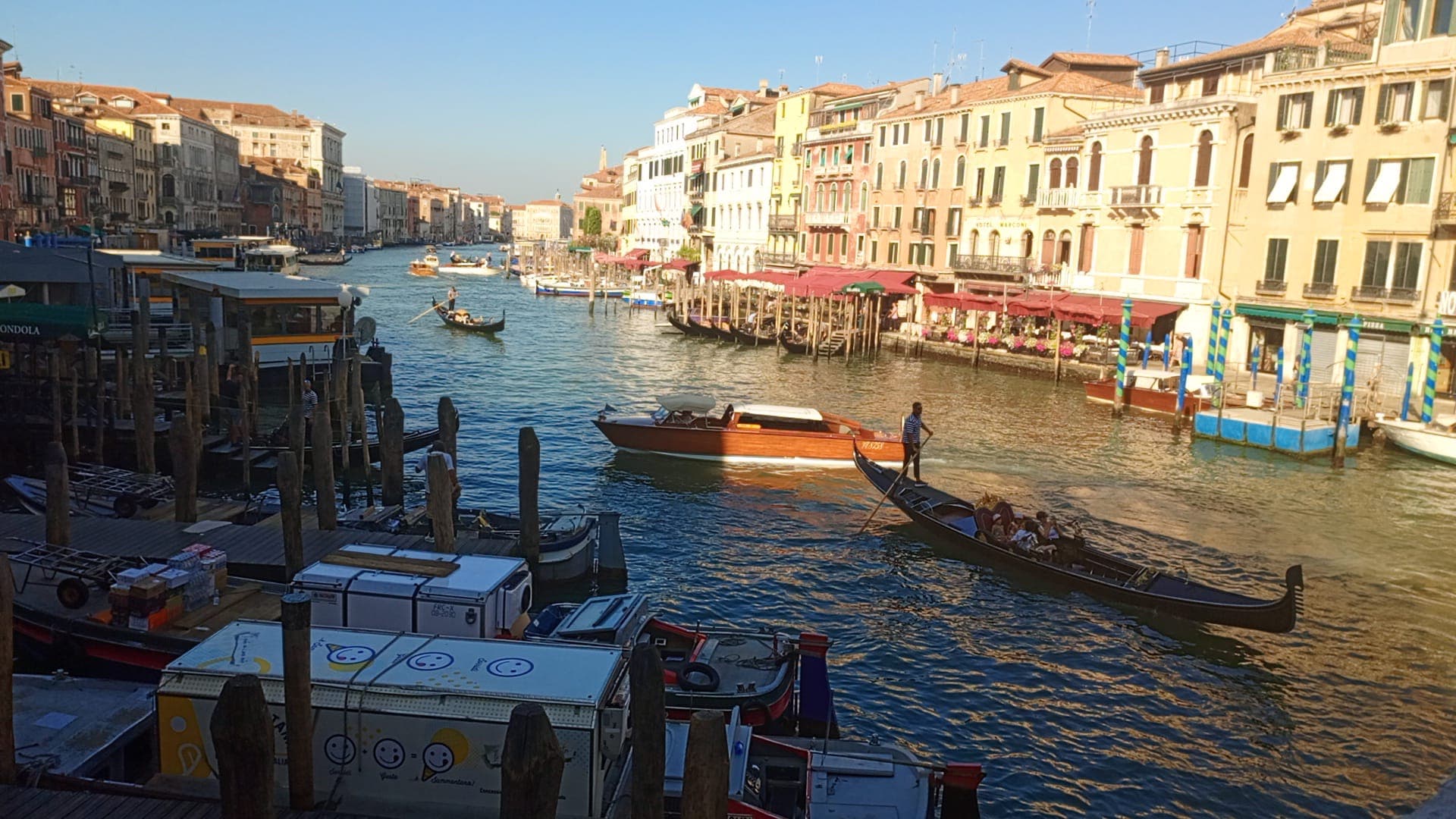View of the Grand Canal with gondolas and boats passing by.