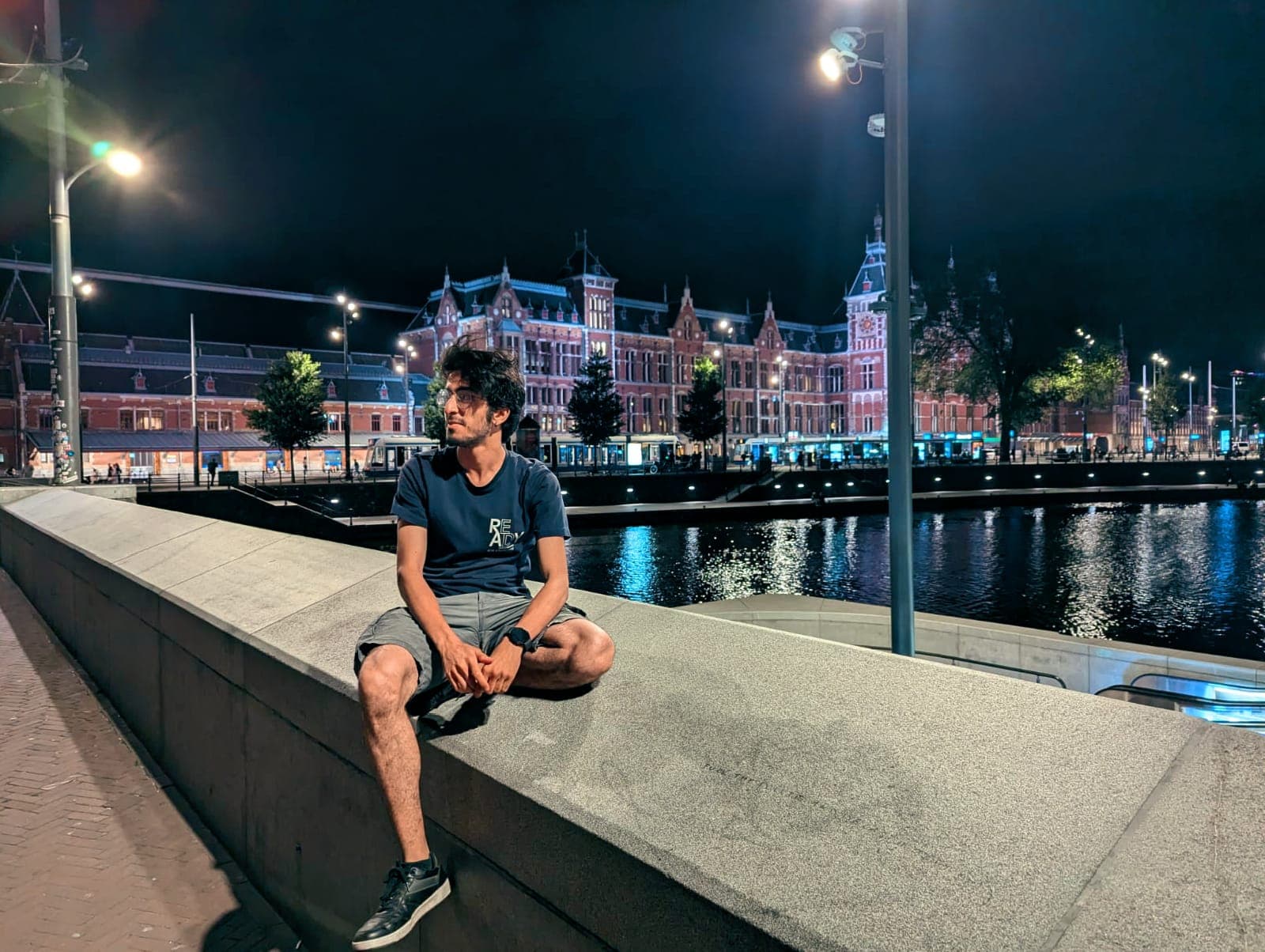 Sitting by the water in Amsterdam, enjoying the skyline and fresh breeze.