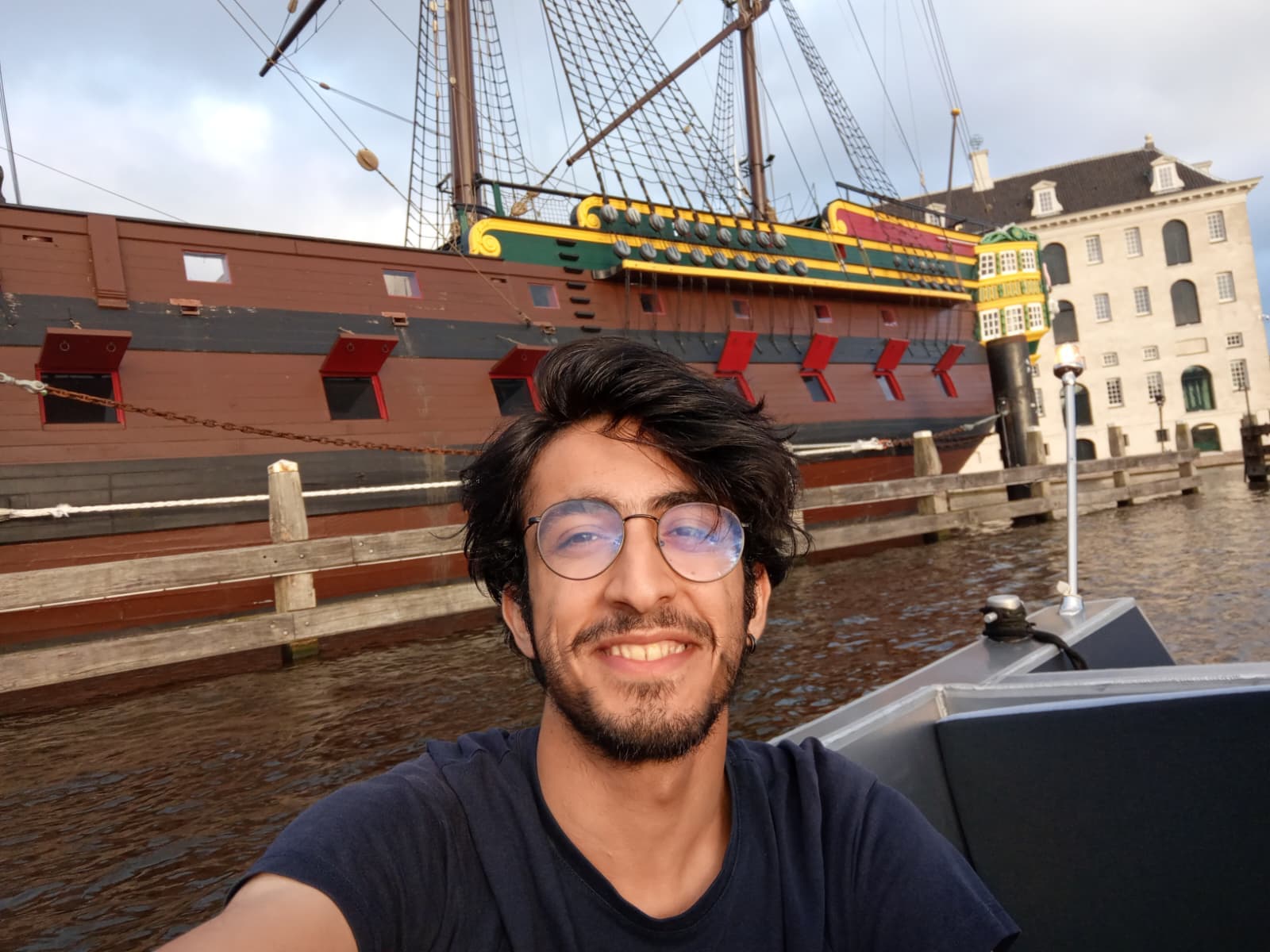 On a boat ride with the historic VOC ship in the background.