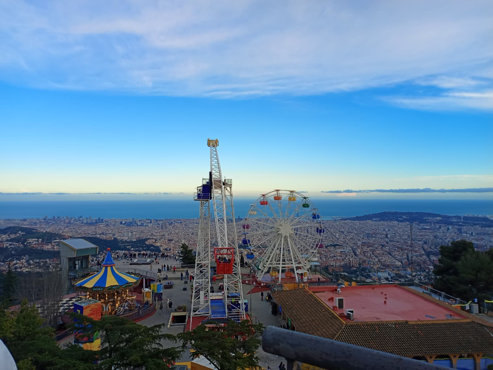 View from Tibidabo Amusement Park with the ferris wheel and the city in the background.