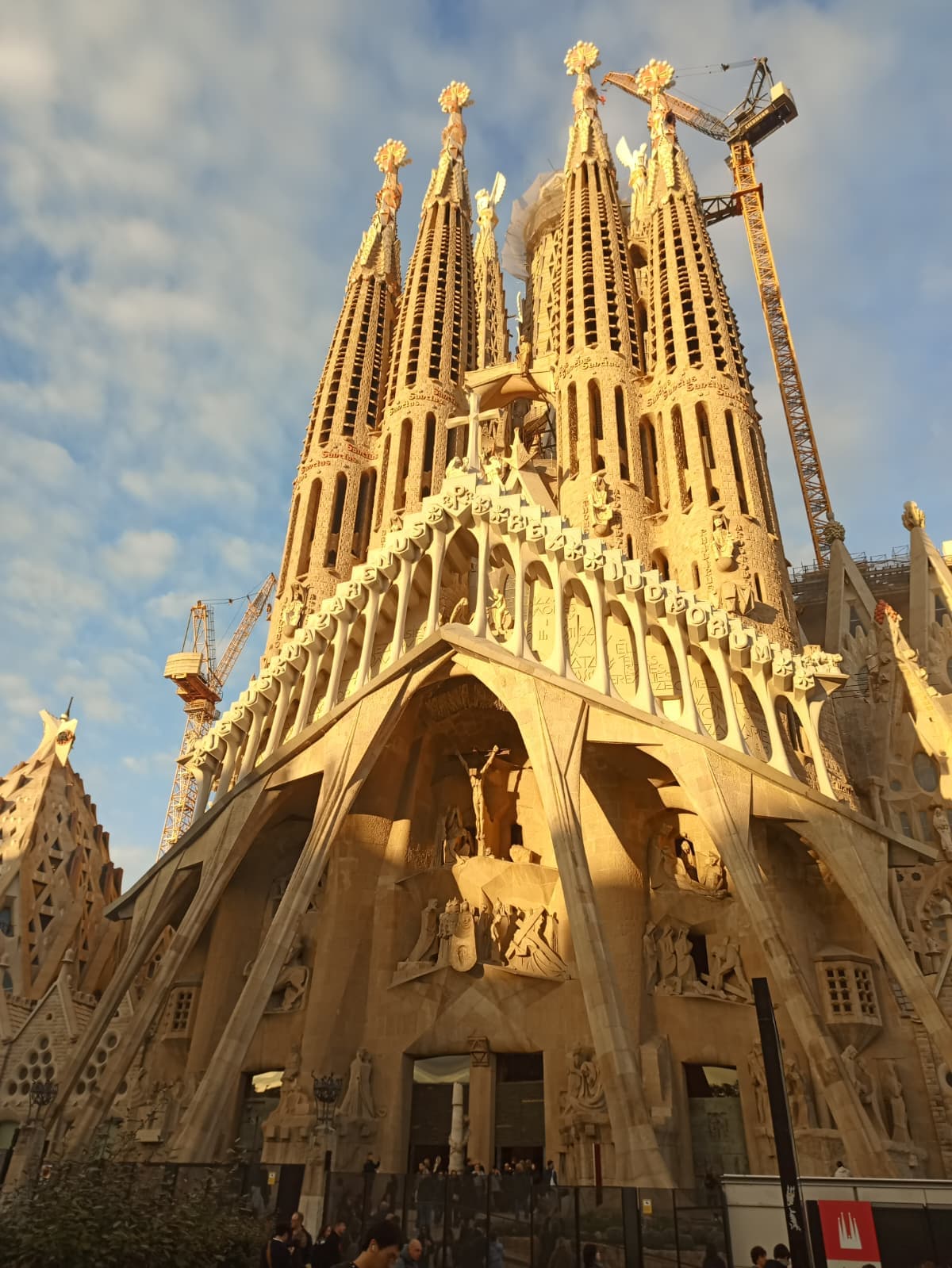 Close-up of La Sagrada Família bathed in golden sunlight.