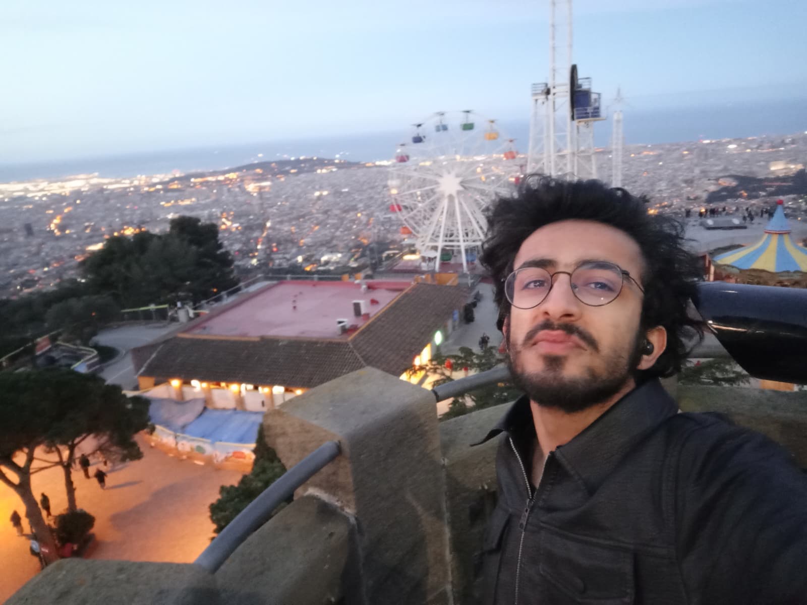Selfie with Tibidabo Amusement Park and the city lights in the background.