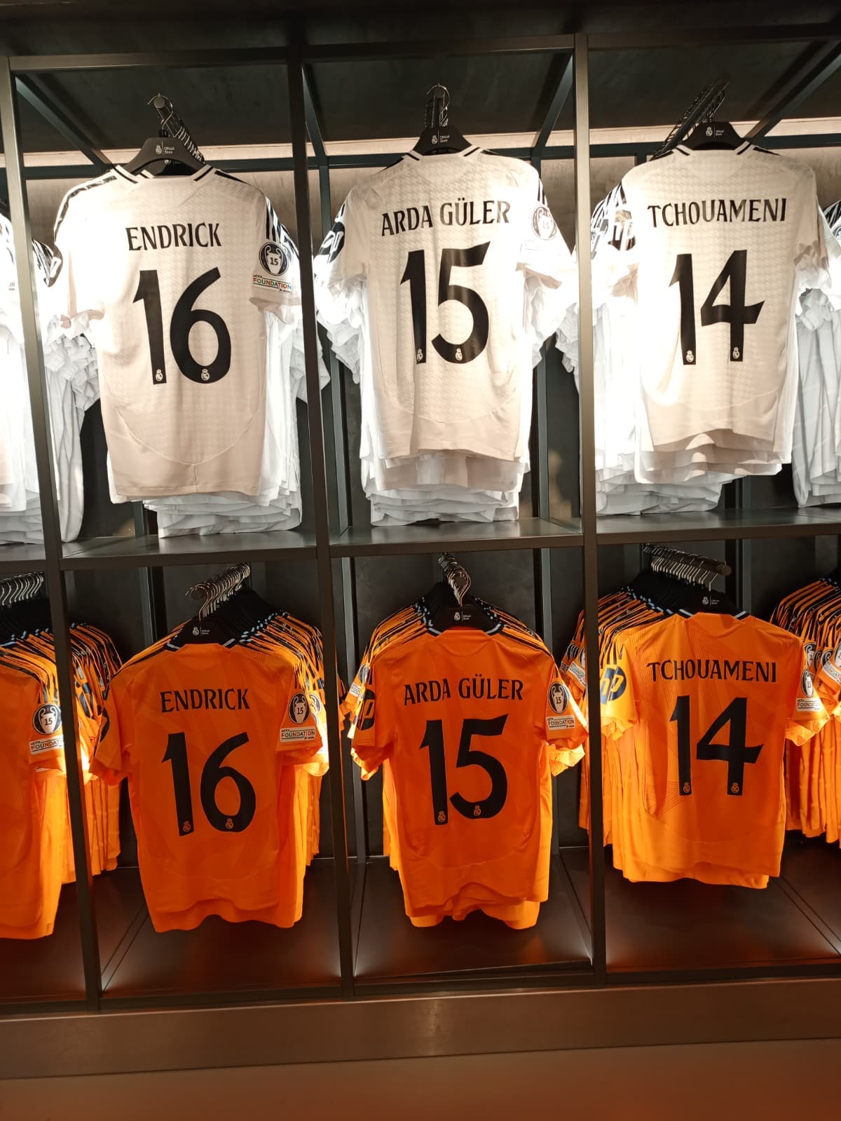 Real Madrid jerseys on display, featuring names like Endrick, Arda Güler, and Tchouaméni.