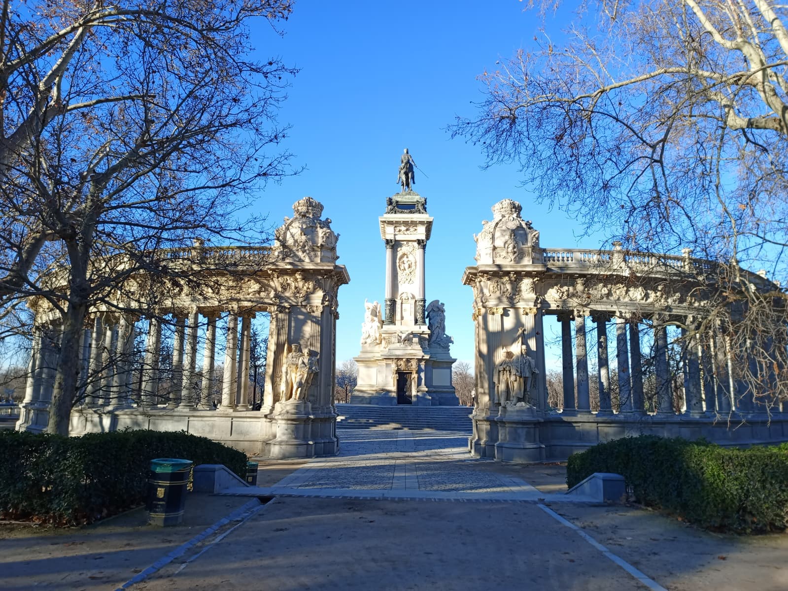 Walking through Parque del Retiro with a clear blue winter sky.